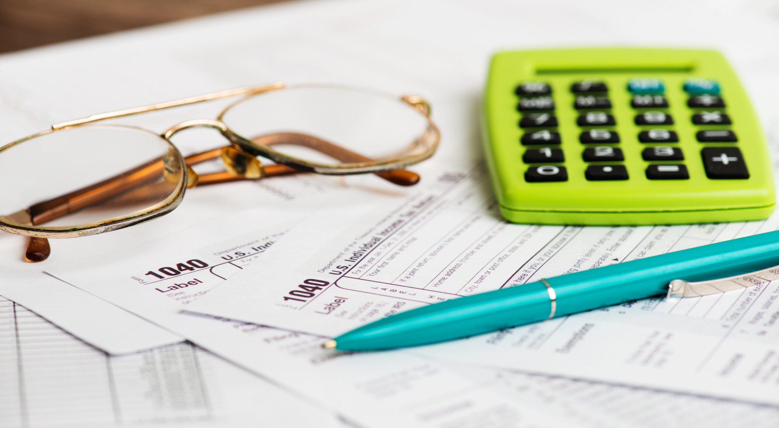 Business work station with paperwork income tax return, calculat