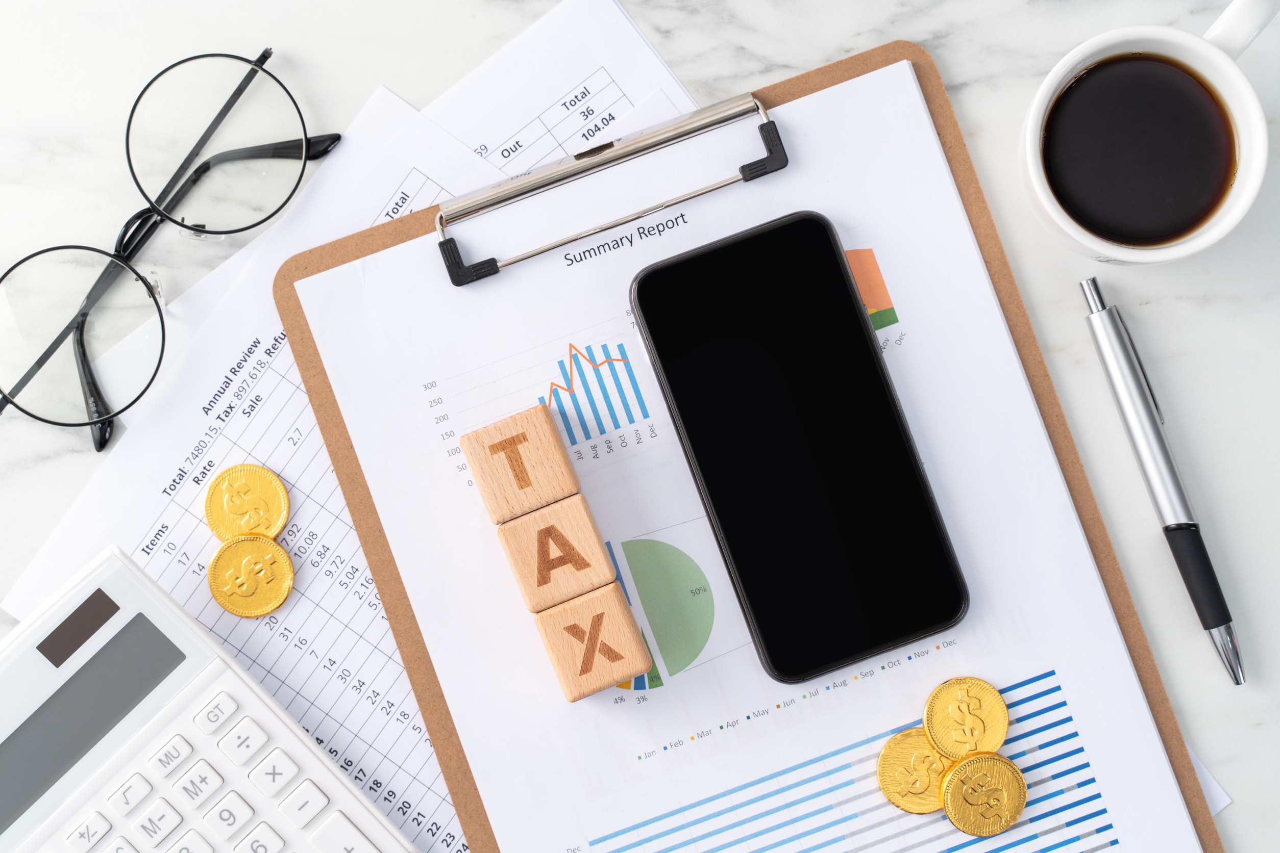 Top view of calculating and paying tax with smart phone on white table